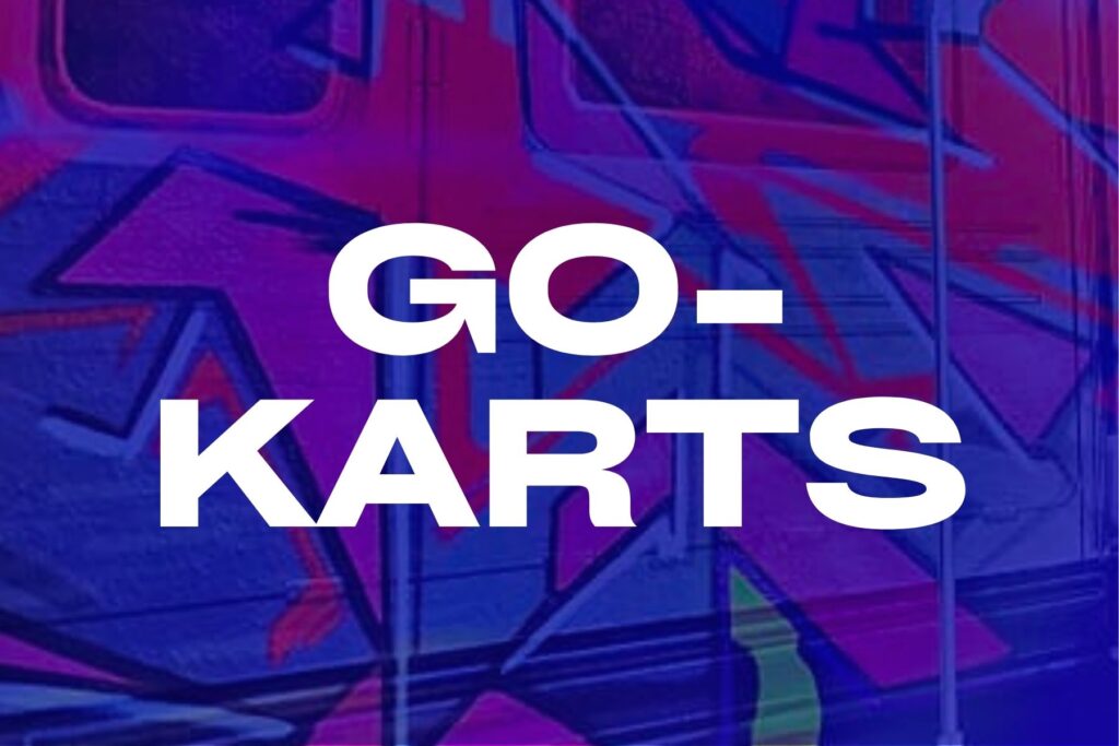 Graffiti-covered bus at The Rush Funplex featuring the words "go-karts" prominently displayed.
