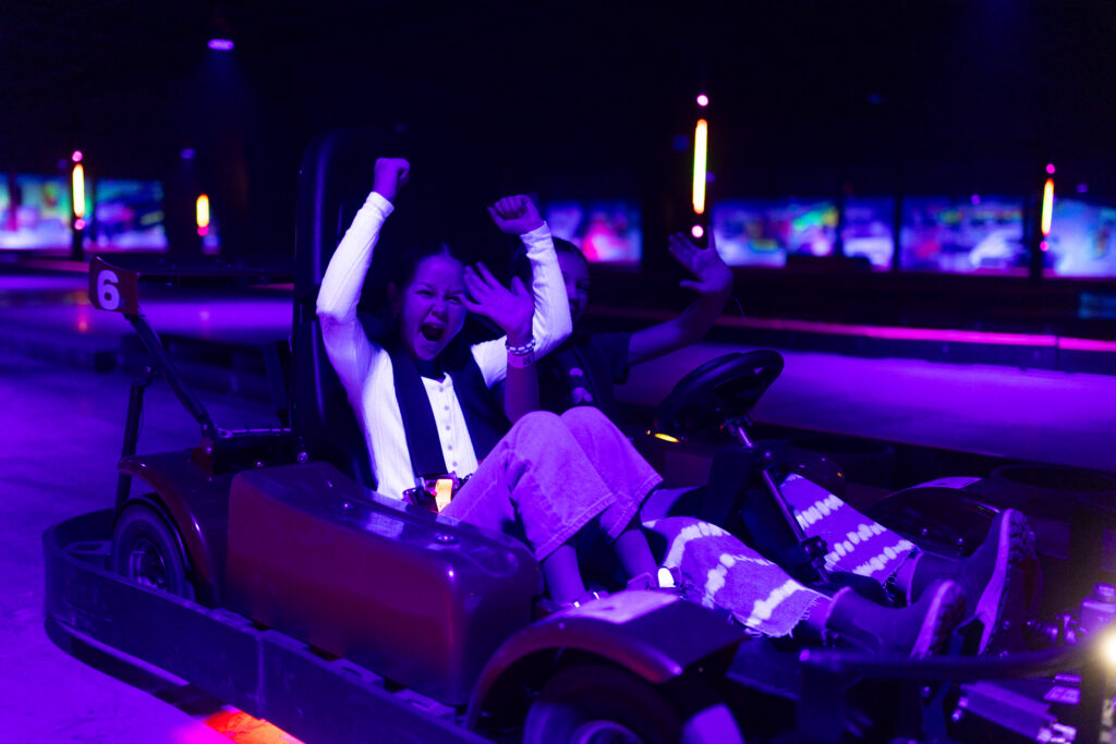 Go-kart racing at night with two participants at The Rush Funplex, showcasing a lively and illuminated racing environment.